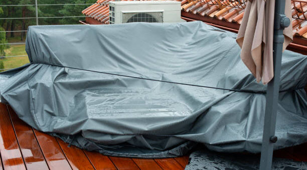 Terrace furniture Cover protecting outdoor furniture from rain. Rainy day.